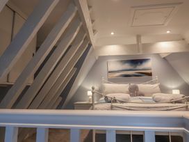 A bedroom with a bed and lamps at The Nutshell in Aldeburgh