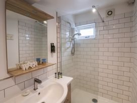 A bathroom with a shower and sink at The Nutshell in Aldeburgh