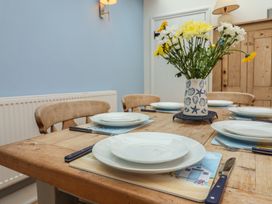 A dining room with a table set for meals at The Nutshell in Aldeburgh