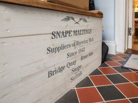 A storage box with text in an entryway at The Nutshell in Aldeburgh