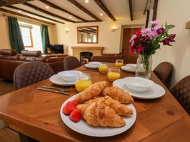A dining room with a table set for breakfast at Dove Cottage in Sneaton near Ruswarp