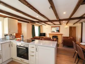 A kitchen with a stove and dining area at Dove Cottage in Sneaton near Ruswarp