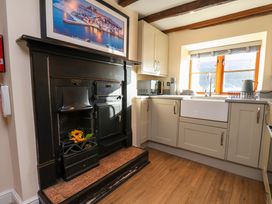 A kitchen with cabinets and stove at Dove Cottage Sneaton near Ruswarp