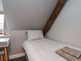 A bedroom with a bed and desk at Dove Cottage in Sneaton near Ruswarp