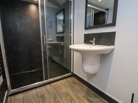 A bathroom with a shower and a sink at Dove Cottage in Sneaton near Ruswarp