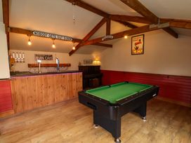 A game room with a pool table and bar at Dove Cottage in Sneaton near Ruswarp