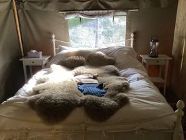 A bedroom with a bed and nightstand at Camnant near Newcastle Emlyn