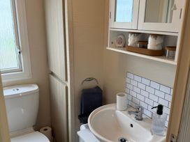 A bathroom with a sink and toilet at Ty Cariad