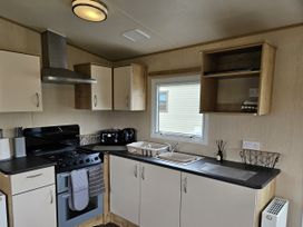 A kitchen with a cooker and sink at Thurston Manor Caravan Park, Pony Meadow, Dunbar