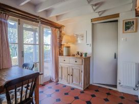A dining room with a table and cabinet at The Little Barn Fluxton Nr. Ottery St Mary