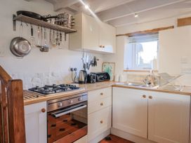 A kitchen with a gas stove and sink at The Little Barn Fluxton Nr. Ottery St Mary
