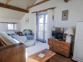 A living room with a sofa and television at The Little Barn Fluxton Nr. Ottery St Mary
