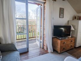 A living room with a television and sofa at The Little Barn Fluxton Nr. Ottery St Mary