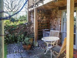 An outdoor seating area with a table and chairs at The Little Barn Fluxton Nr. Ottery St Mary