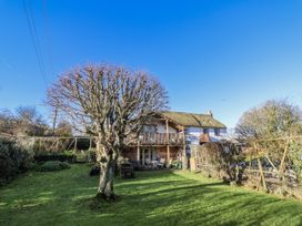 A house with a balcony and tree in the garden at The Little Barn Fluxton Nr. Ottery St Mary