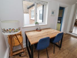 A dining area with a table and lamp at 23 Northumbria Terrace Amble