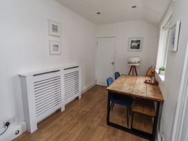 A dining room with a table and chairs at 23 Northumbria Terrace in Amble
