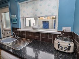 A kitchen with a sink and a toaster at 23 Northumbria Terrace Amble