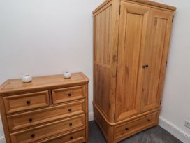 A chest of drawers and wardrobe in a bedroom at 23 Northumbria Terrace in Amble