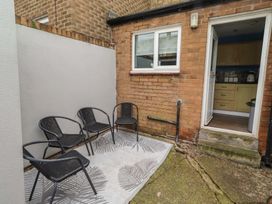A garden with chairs and a doorway at 23 Northumbria Terrace Amble