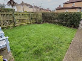 A garden with grass and a fence at 23 Northumbria Terrace Amble