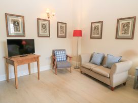 A living room with a television and seating area at Woodcock Studio Andoversford near Cheltenham