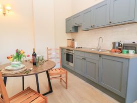 A kitchen with a table set for a meal at Swallow Studio Andoversford near Cheltenham