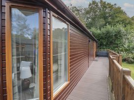 An outdoor view of a wooden deck with windows at 32 Grasmere Windermere