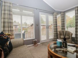 A snug with a sofa and coffee table at 32 Grasmere, White Cross Bay near Windermere