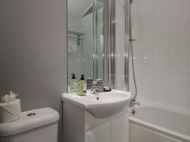 A bathroom with a sink and bathtub at 32 Grasmere, White Cross Bay near Windermere