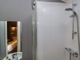 A shower with a mirror and sink at 32 Grasmere, White Cross Bay near Windermere