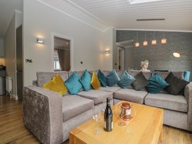 A living room with a sofa and coffee table at 7 Lake View in Windermere