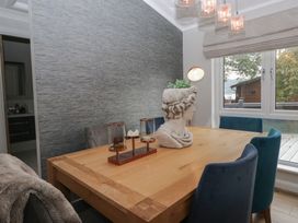 A dining room with a wooden table and chairs at 7 Lake View in Windermere