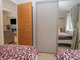 A bedroom with two beds and a television at 7 Lake View Windermere