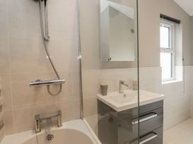 A bathroom with a shower, sink and bath at 7 Lake View Windermere