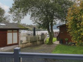 An outdoor area with a wooden cabin and water view at 7 Lake View in Windermere