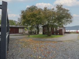 An outdoor area with trees and buildings at 7 Lake View Windermere