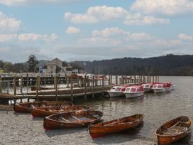 A dock with boats and a building at 7 Lake View, Windermere