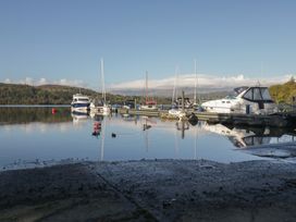 A marina with boats and calm water at 7 Lake View, Windermere