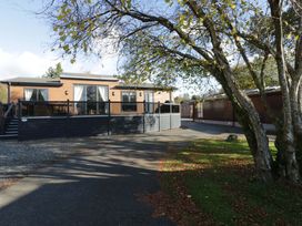 A house with a deck and surrounding trees at 7 Lake View, Lake View 7, White Cross Bay near Windermere