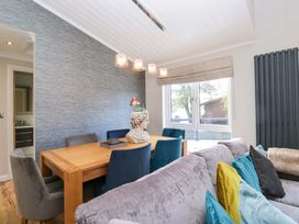 A dining room with a table and chairs at 7 Lake View, White Cross Bay near Windermere