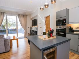 A kitchen with a gray island and wine bottles at 7 Lake View, Lake View 7, White Cross Bay near Windermere