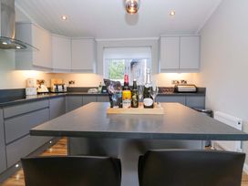 A kitchen with an island and bottles on it at 7 Lake View, Lake View 7, White Cross Bay near Windermere