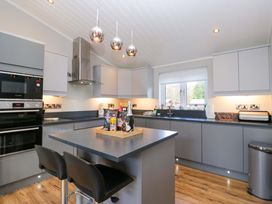 A kitchen with gray cabinets and appliances at 7 Lake View, Lake View 7, White Cross Bay near Windermere
