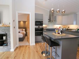 A kitchen with cabinets and bar stools at 7 Lake View, Lake View 7, White Cross Bay near Windermere