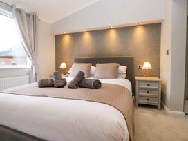 A bedroom with a bed and nightstand at 7 Lake View, Lake View 7, White Cross Bay near Windermere