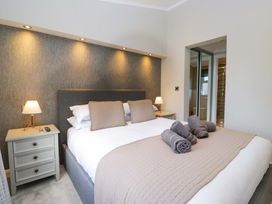 A bedroom with a bed and bedside table at 7 Lake View, Lake View 7, White Cross Bay near Windermere