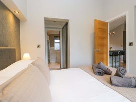 A bedroom with a bed and towels at 7 Lake View, Lake View 7, White Cross Bay near Windermere