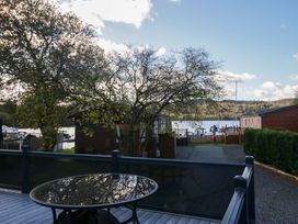 An outdoor area with a table and trees near water at 7 Lake View, Lake View 7, White Cross Bay near Windermere