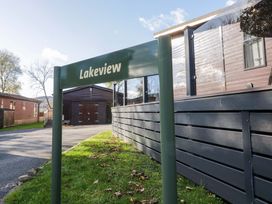 A sign labeled Lakeview near wooden cabins at 7 Lake View, Lake View 7, White Cross Bay near Windermere